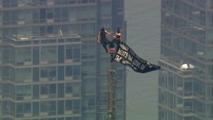 HT13. Masked climbers get engaged on the spire of the Empire State Building
